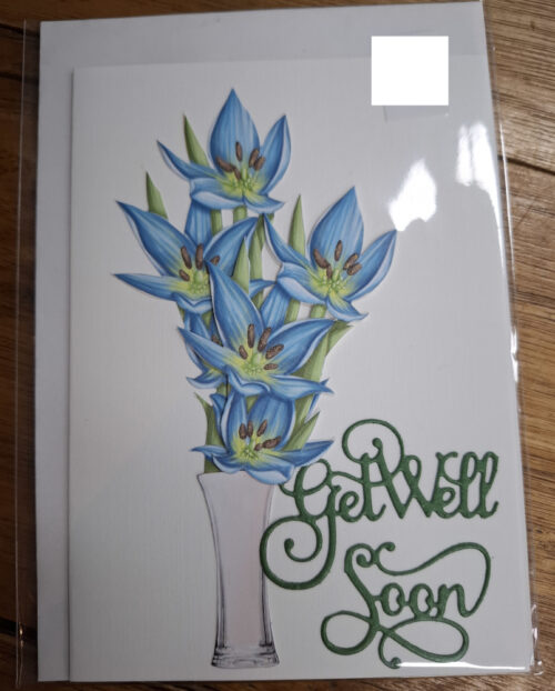 vase with flowers and get well soon message on a card