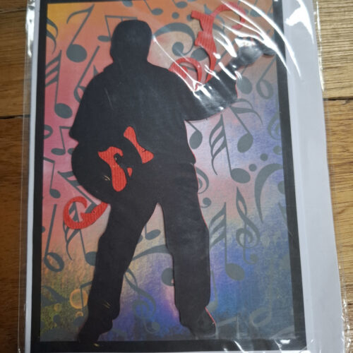 figure rocking away on a quitar on a card