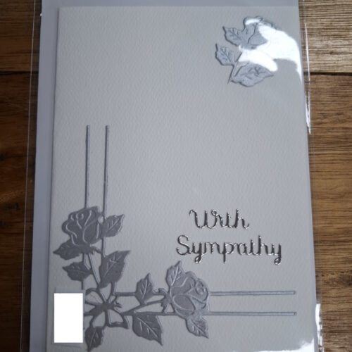 Peaceful silver flowers corner display with with sympathy message on card