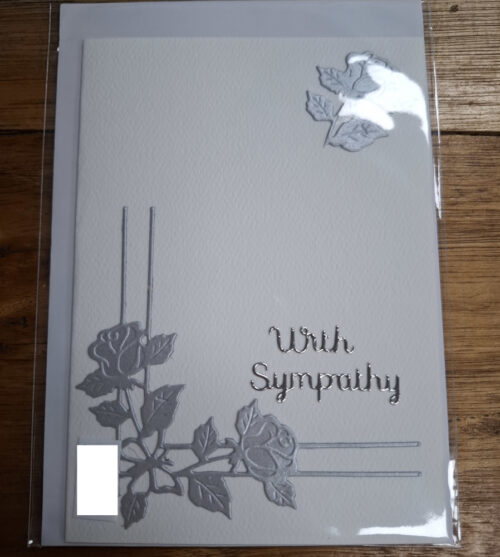 Peaceful silver flowers corner display with with sympathy message on card
