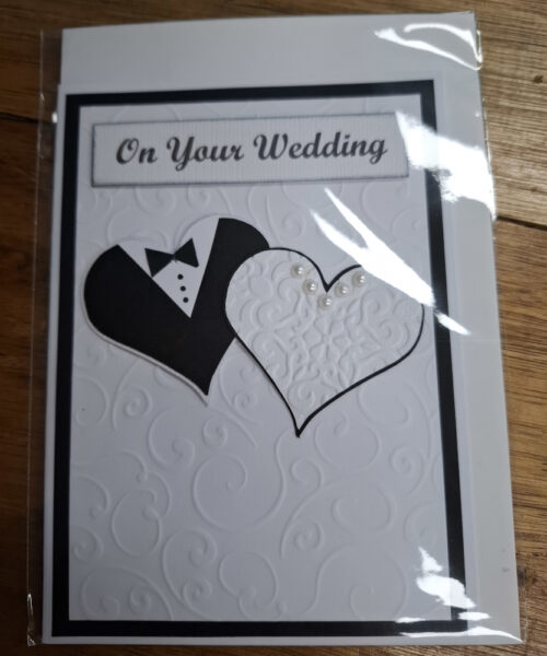 two hearts looking like a wedding dress and tux on a card
